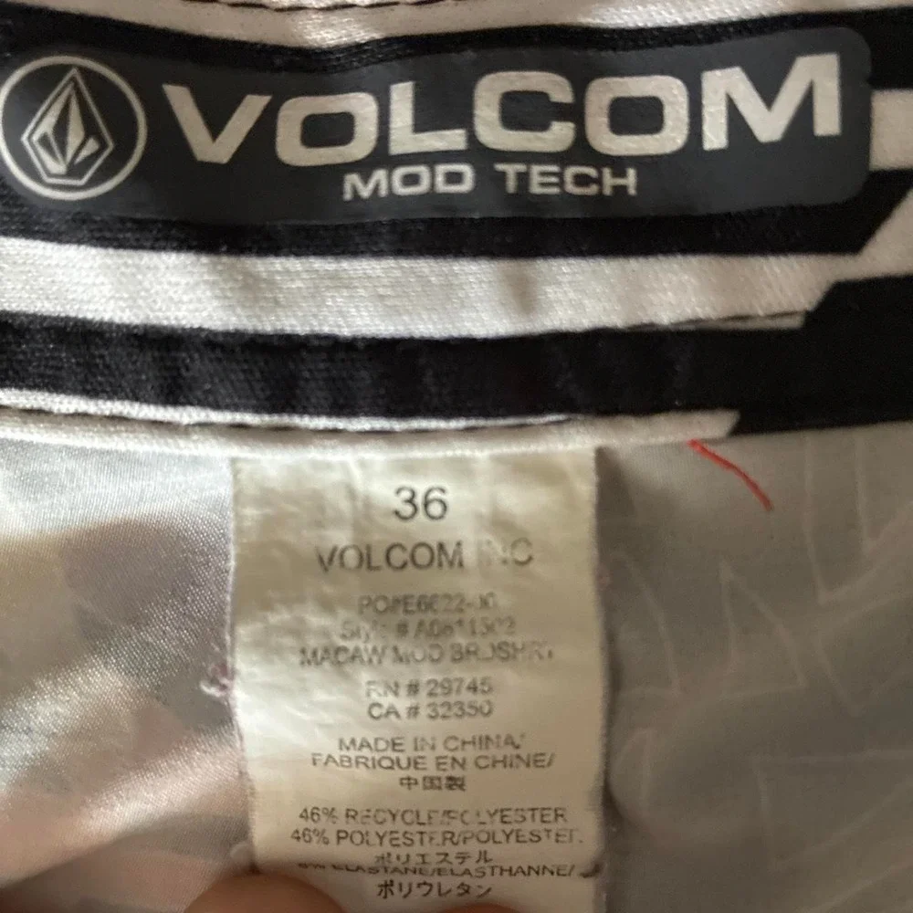 Preowned 2015 Volcom board shorts with orange, white, and black abstract